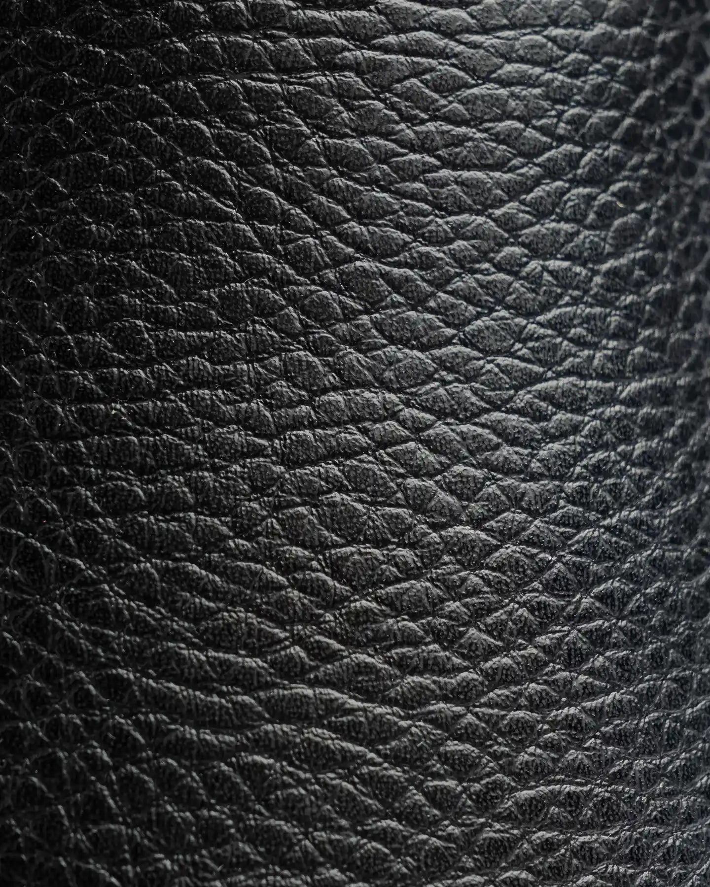 Close-up of Snibbs The Clog - Black Speckle: vegan leather, pebble texture, water resistant, non-slip sole.