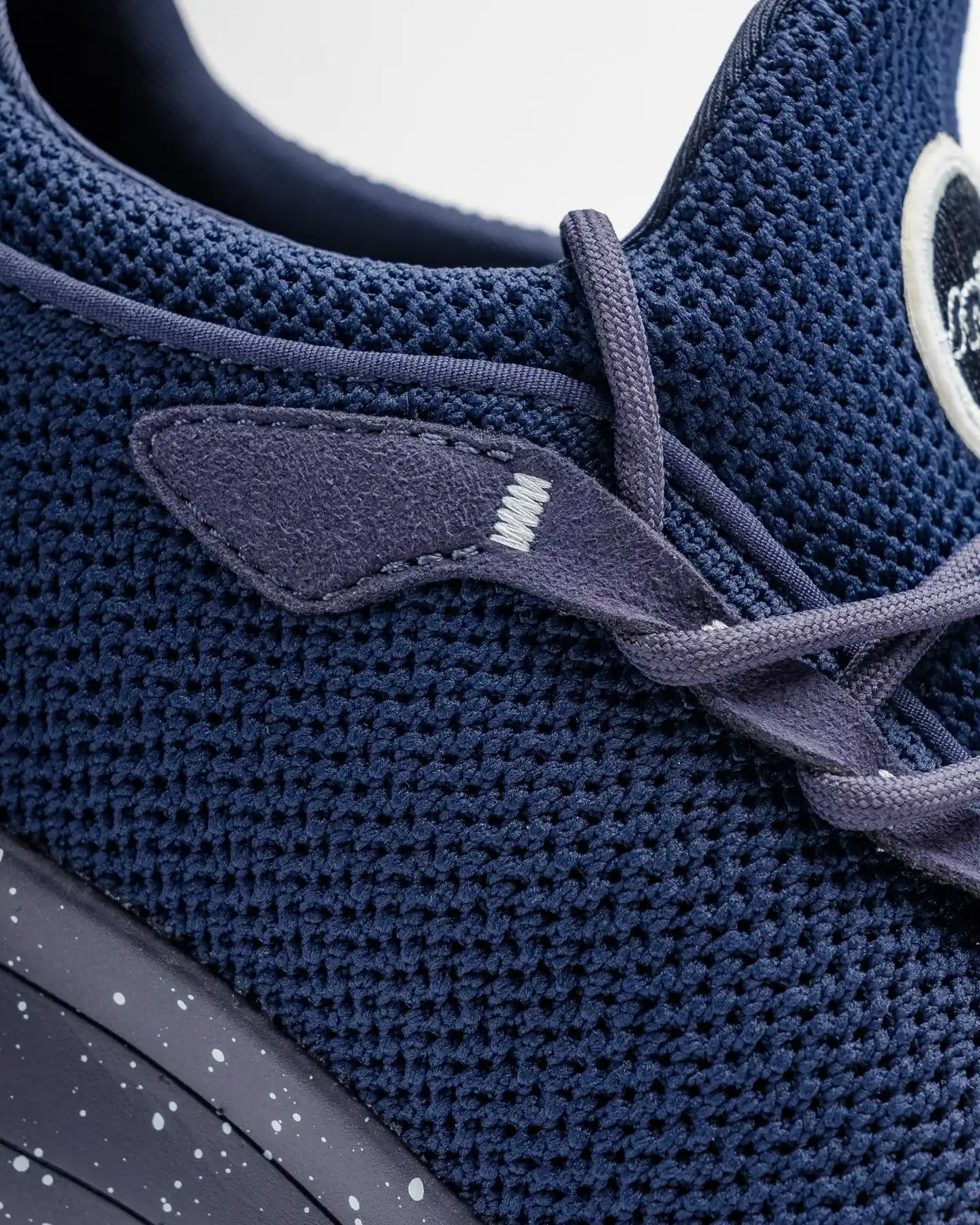 Close-up of Snibbs Orbit in Nebula Blue, featuring a breathable knit upper, dark laces, and a speckled slip-resistant midsole.