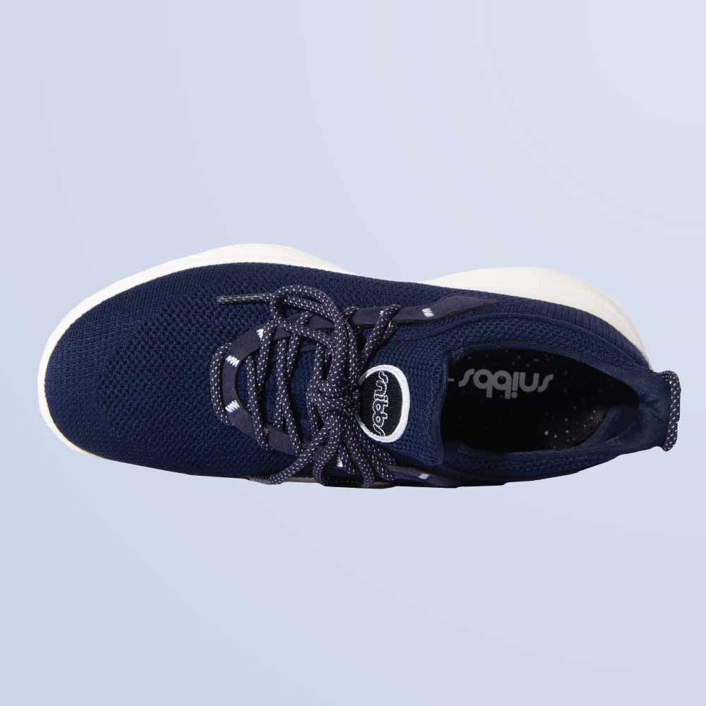 Snibbs Orbit - Maritime Blue: top view of a lightweight sneaker with breathable knit upper and patterned laces, on light blue.