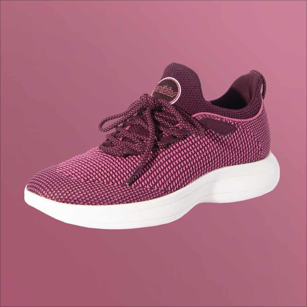 The Snibbs Orbit - Wine Tasting shoe features a breathable knit upper and white sole, displayed angled on a pink background.