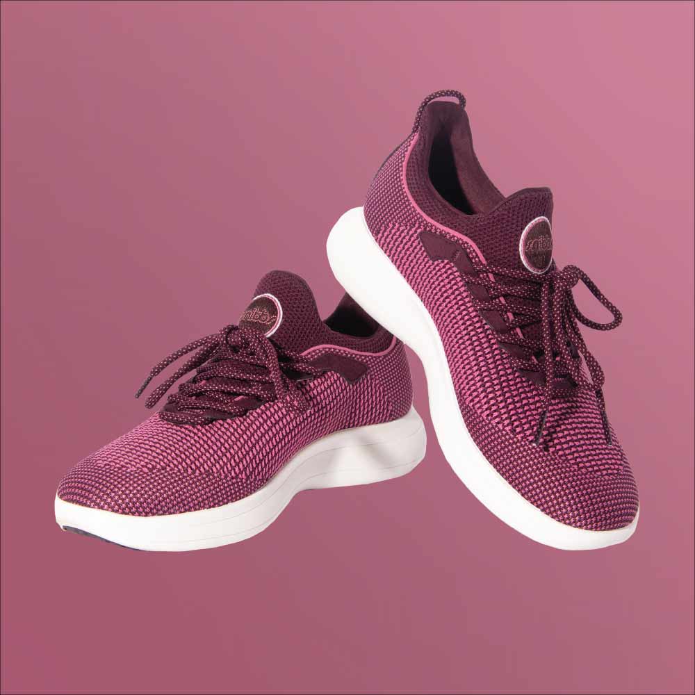 Snibbs Orbit - Wine Tasting sneakers with breathable knit uppers and white soles are displayed on a light magenta background.