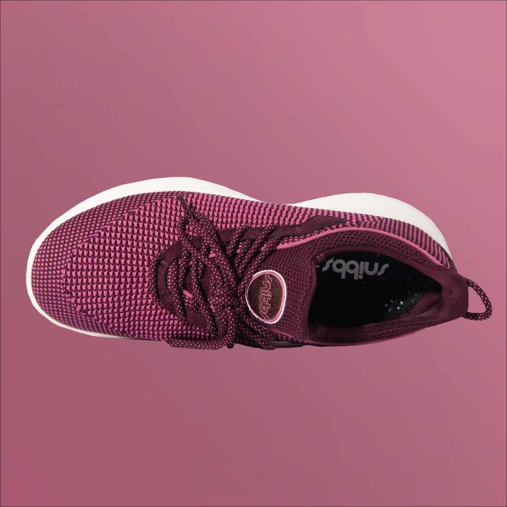 Snibbs Orbit - Wine Tasting: maroon knit athletic shoe with white sole, top view on a maroon background.