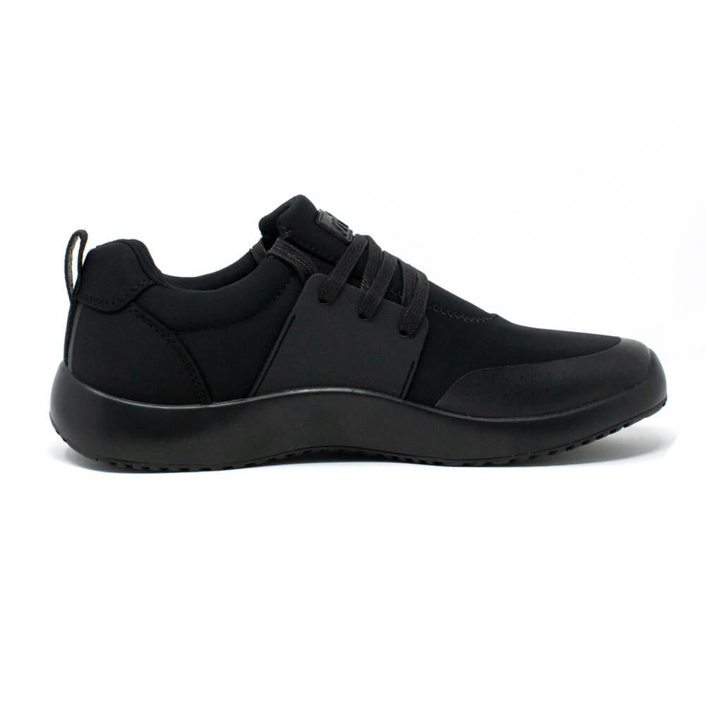 A black running sneaker is shown in a side view on a white background. The shoe features black laces, a low profile, and a thick rubber sole.