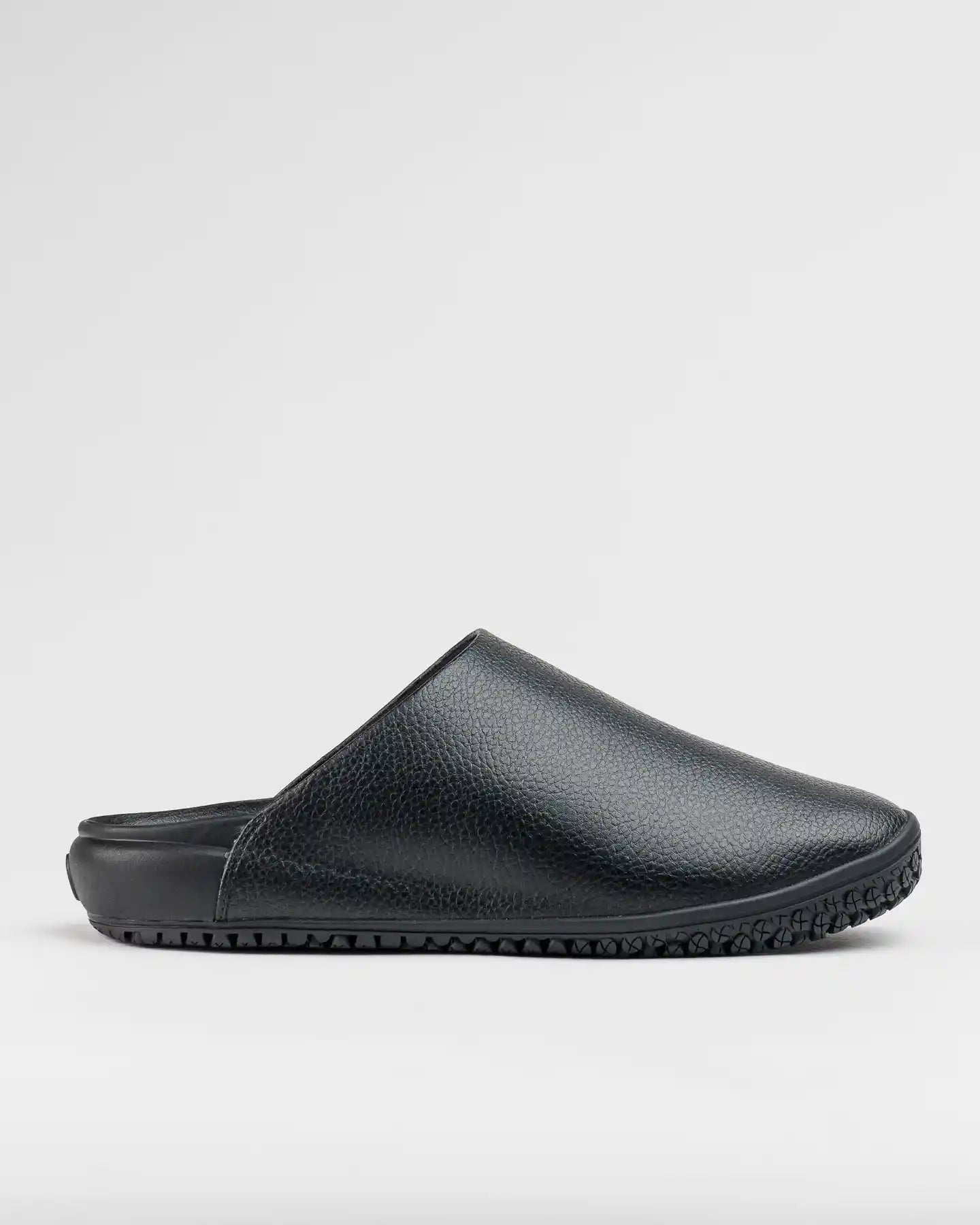 The Snibbs The Clog - Eclipse Black is a black, textured slip-on mule with a rubber sole and non-slip work design, shown in profile.