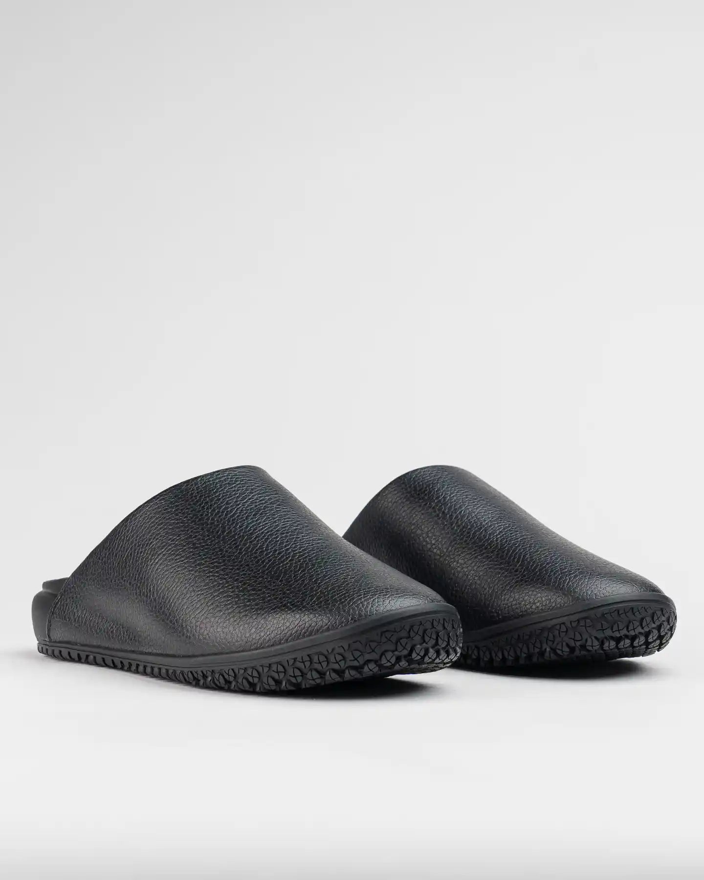 The Clog - Eclipse Black by Snibbs, featuring textured uppers and non-slip soles, is shown against a plain light background.