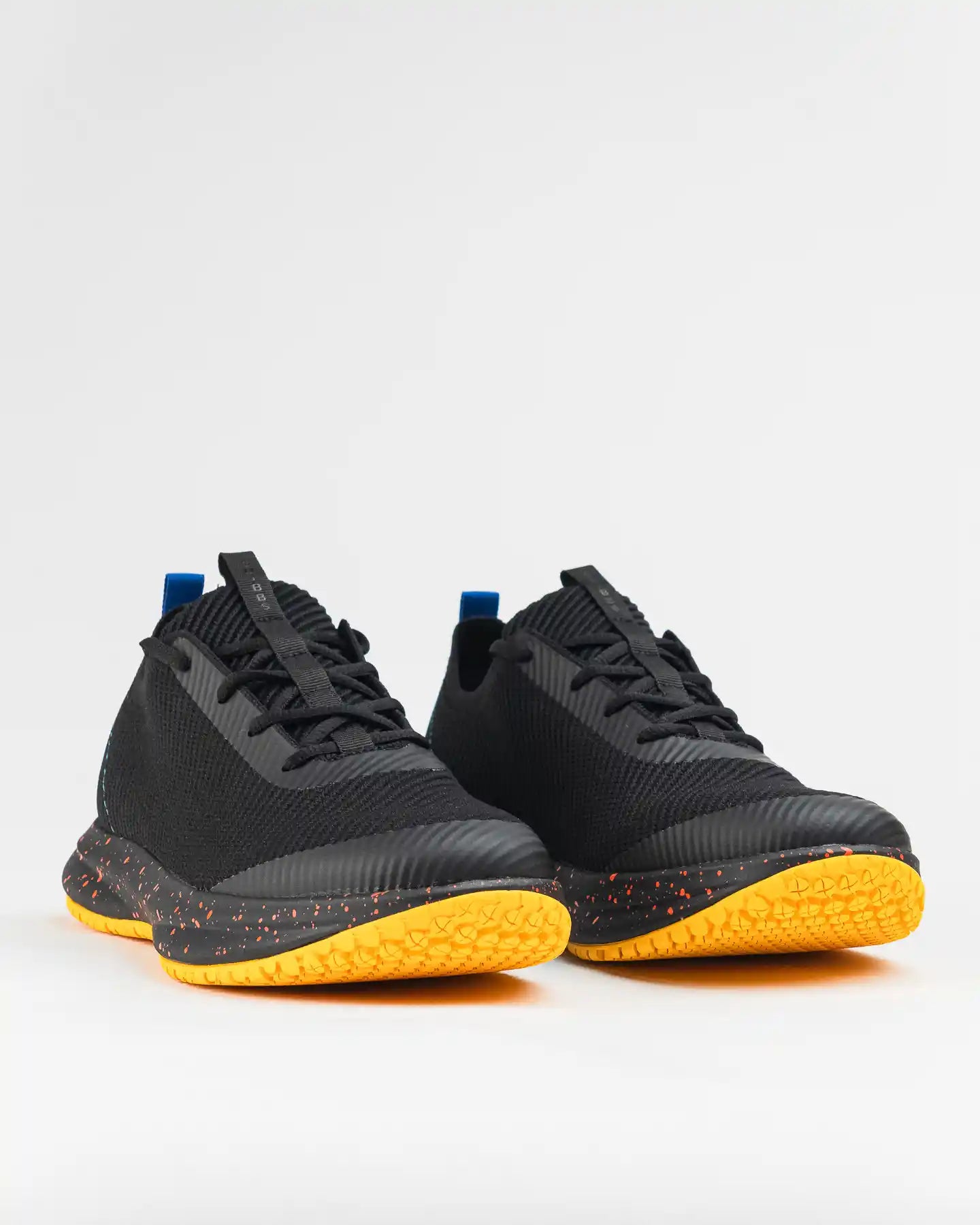 Snibbs ROVR - WCK (VN) black athletic shoes with yellow-orange speckled soles on a white background.