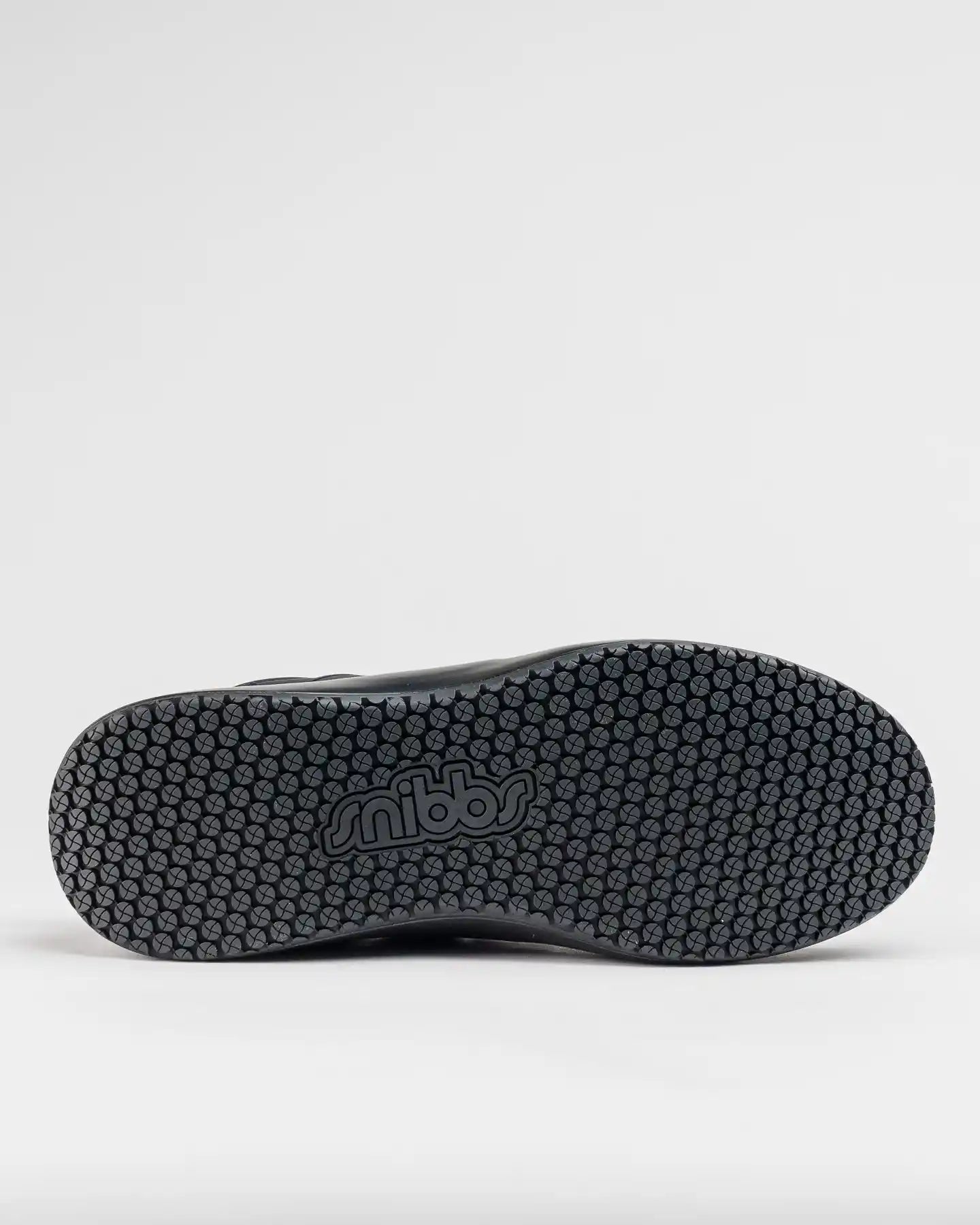 The image shows the textured, slip-resistant sole of the Spacecloud 2.0 - Eclipse Black by Snibbs, with "snibbs" embossed.