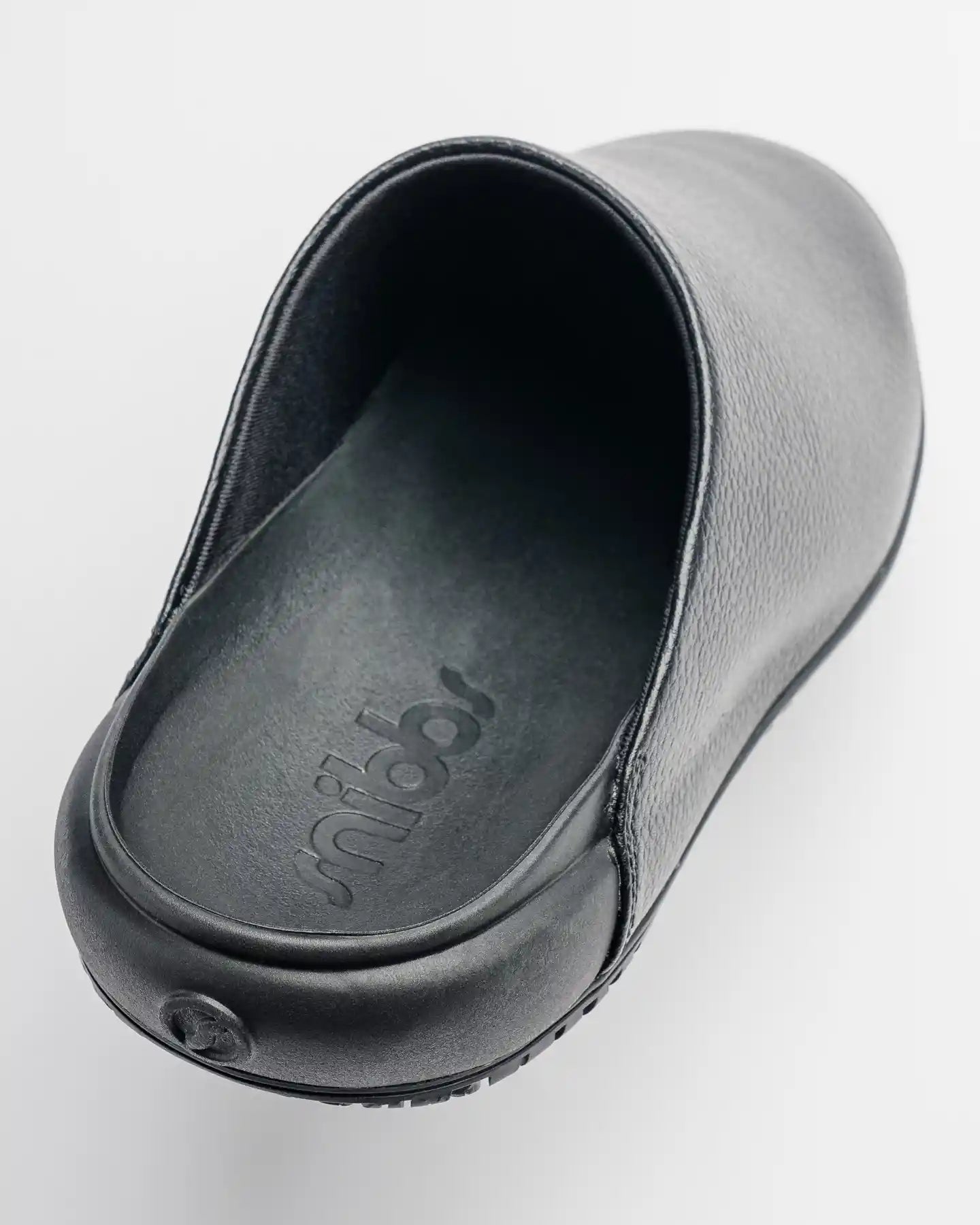 The Clog - Eclipse Black by Snibbs: A black vegan leather slip-on with closed toe, non-slip sole, and insole branding.