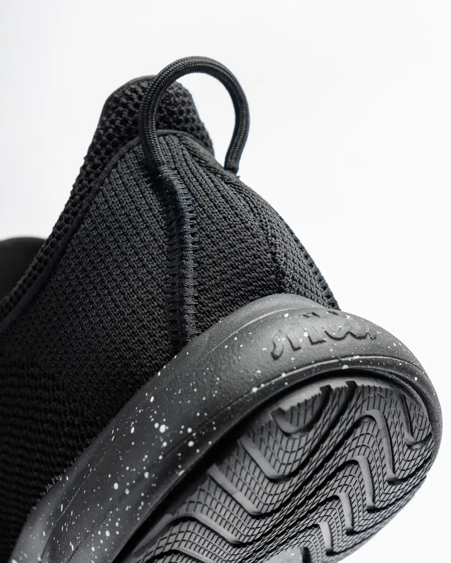 Close-up of Snibbs Orbit - Black Speckle heel and slip-resistant sole, shown against a white background.