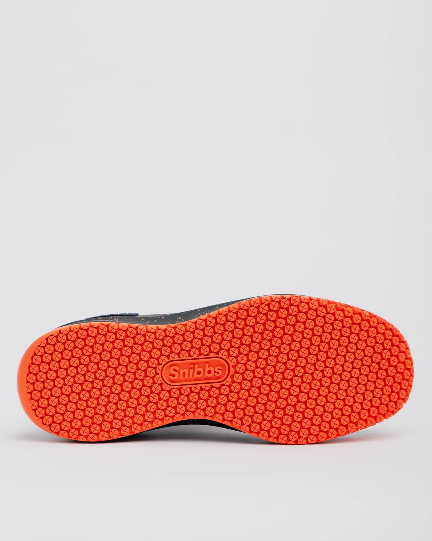 The Pro - Tangerine shoe features an orange non-slip outsole with Snibbs embossed at the center.