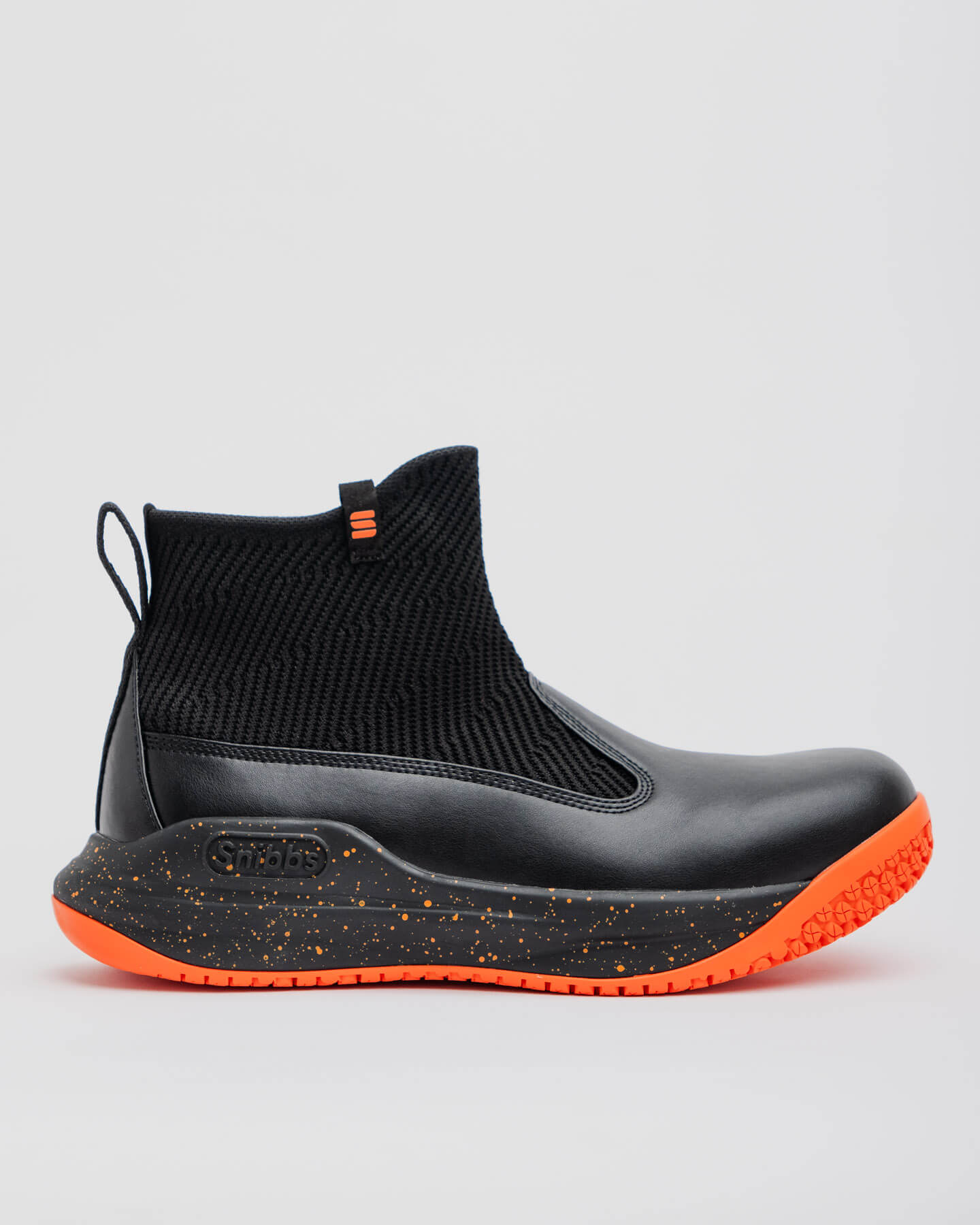 The Snibbs Pro - Tangerine: a black ankle boot with a textured knit upper, orange-speckled sole, and non-slip outsole, shown in profile.