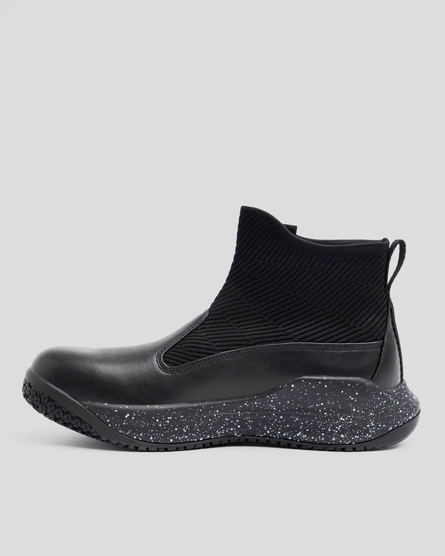 Snibbs Pro - Black Speckle: Black knit ankle shoe with non-slip sole and speckled midsole, side view on gray background.