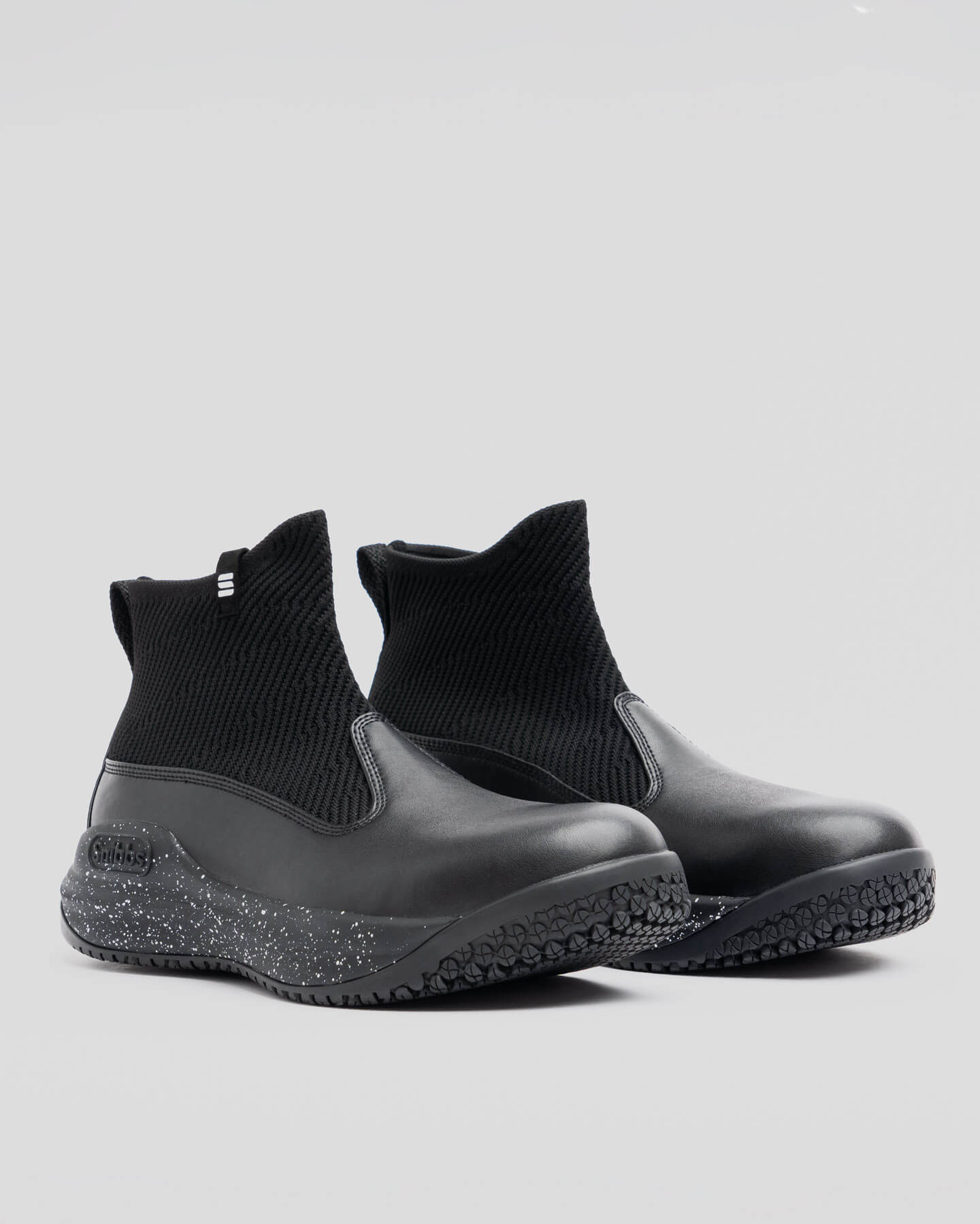 Snibbs Pro - Black Speckle slip-ons with maximum cushioning and non-slip outsoles, shown on a plain light gray background.