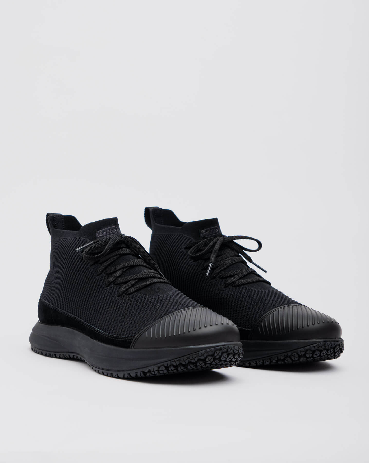 Snibbs ROVR Mid - Eclipse Black (VN): black high-top sneakers with slip-resistant rubber soles and laces on a light gray background.