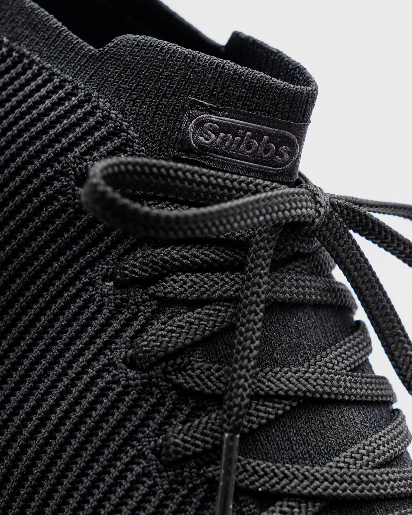 Close-up of the Snibbs ROVR Mid - Eclipse Black (VN) sneaker with slip-resistant sole, shown on a light background.