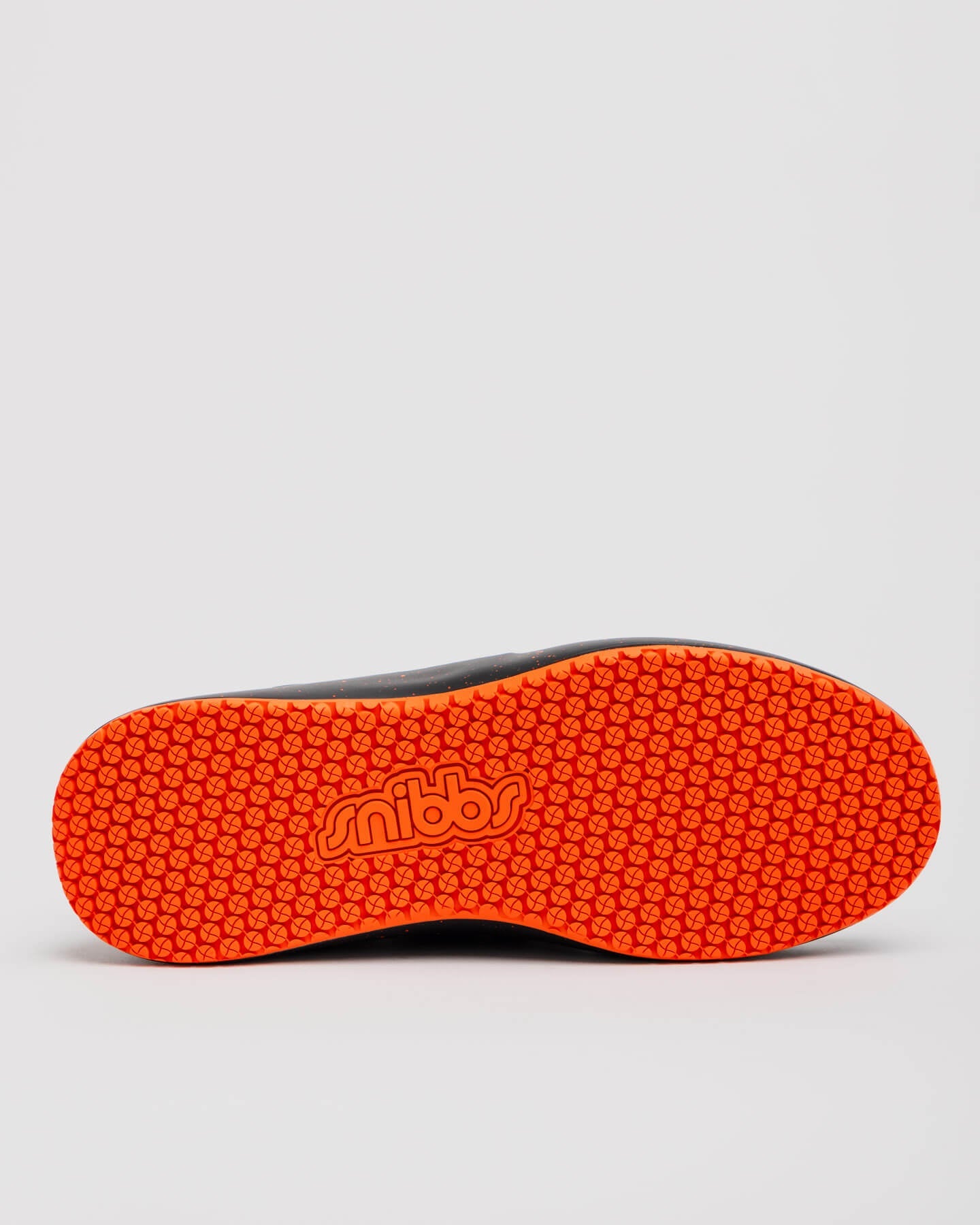 The sole of the Snibbs Spacecloud 2.0 - Tangerine vegan work sneaker features an orange, slip-resistant base and "snibbs" at the center.