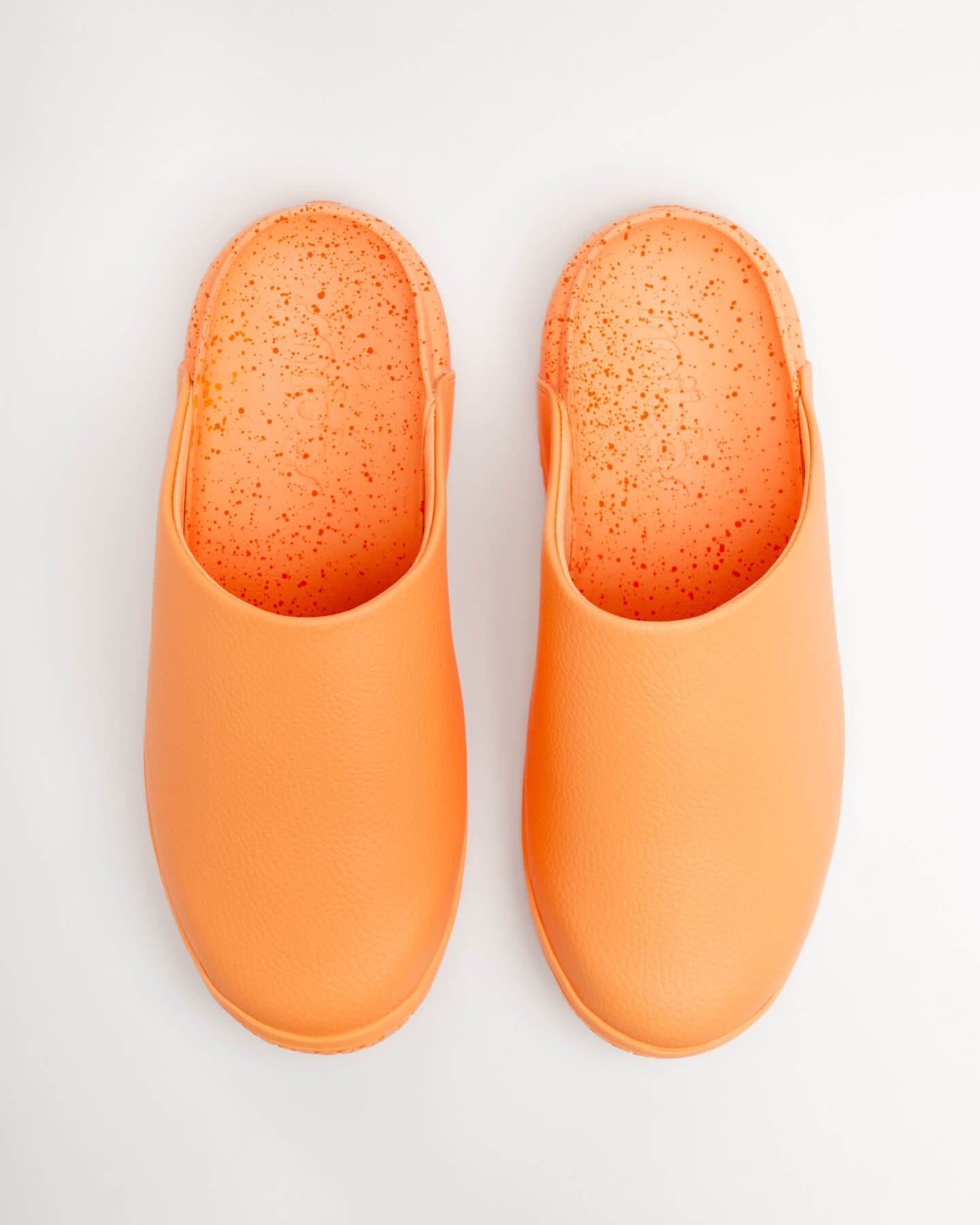 Snibbs The Clog - Tangerine (VN) water-resistant clogs with speckled insoles shown from above on a white background.