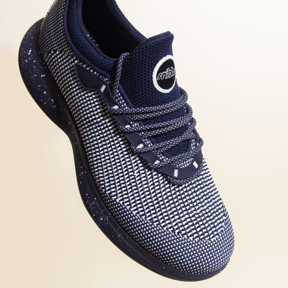 Snibbs Orbit - Blueberry Jam: a navy and white knit sneaker with speckled laces and sole, shown on a light background.