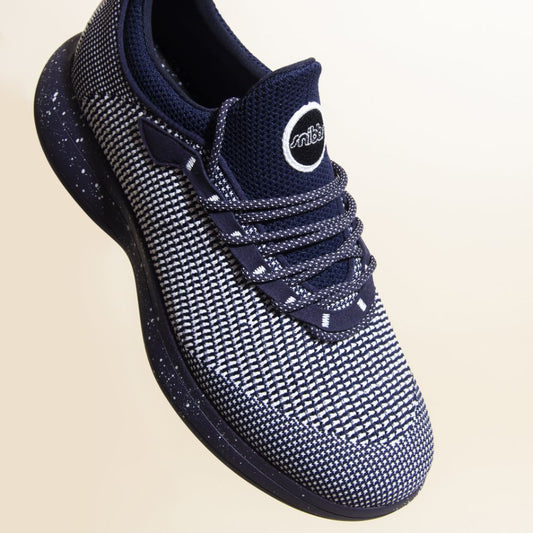 Snibbs Orbit - Blueberry Jam: a navy and white knit sneaker with speckled laces and sole, shown on a light background.