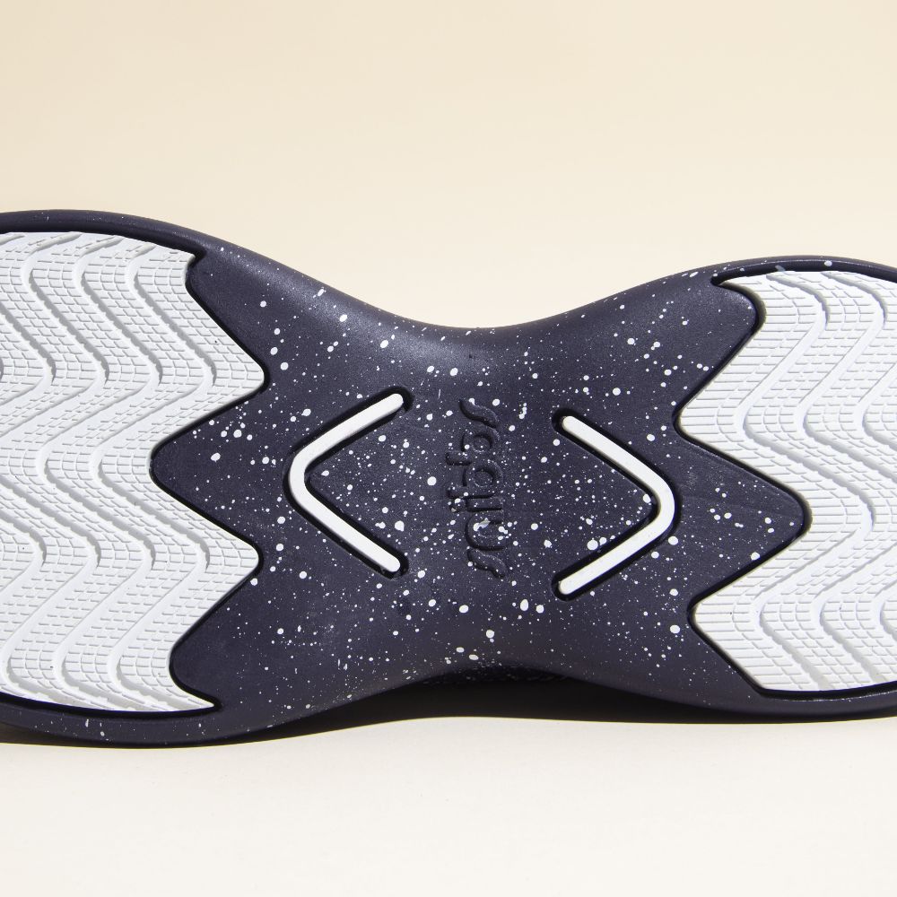 The Orbit - Blueberry Jam by Snibbs has a speckled, slip-resistant outsole with wavy tread and "Snibbs" embossed at the center.