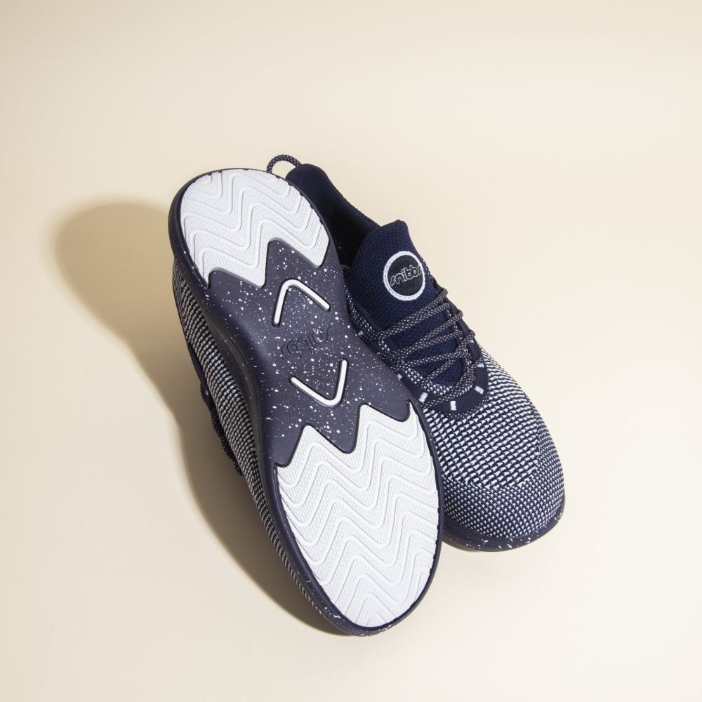 Snibbs Orbit - Blueberry Jam: breathable navy knit sneakers with slip-resistant, wavy-patterned sole; one shoe shown upright.