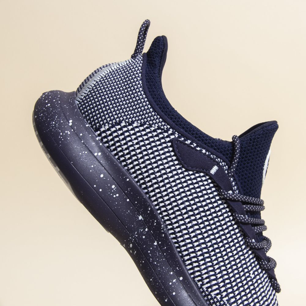 The Snibbs Orbit - Blueberry Jam sneaker with a knit upper and speckled sole is shown against a plain beige background.