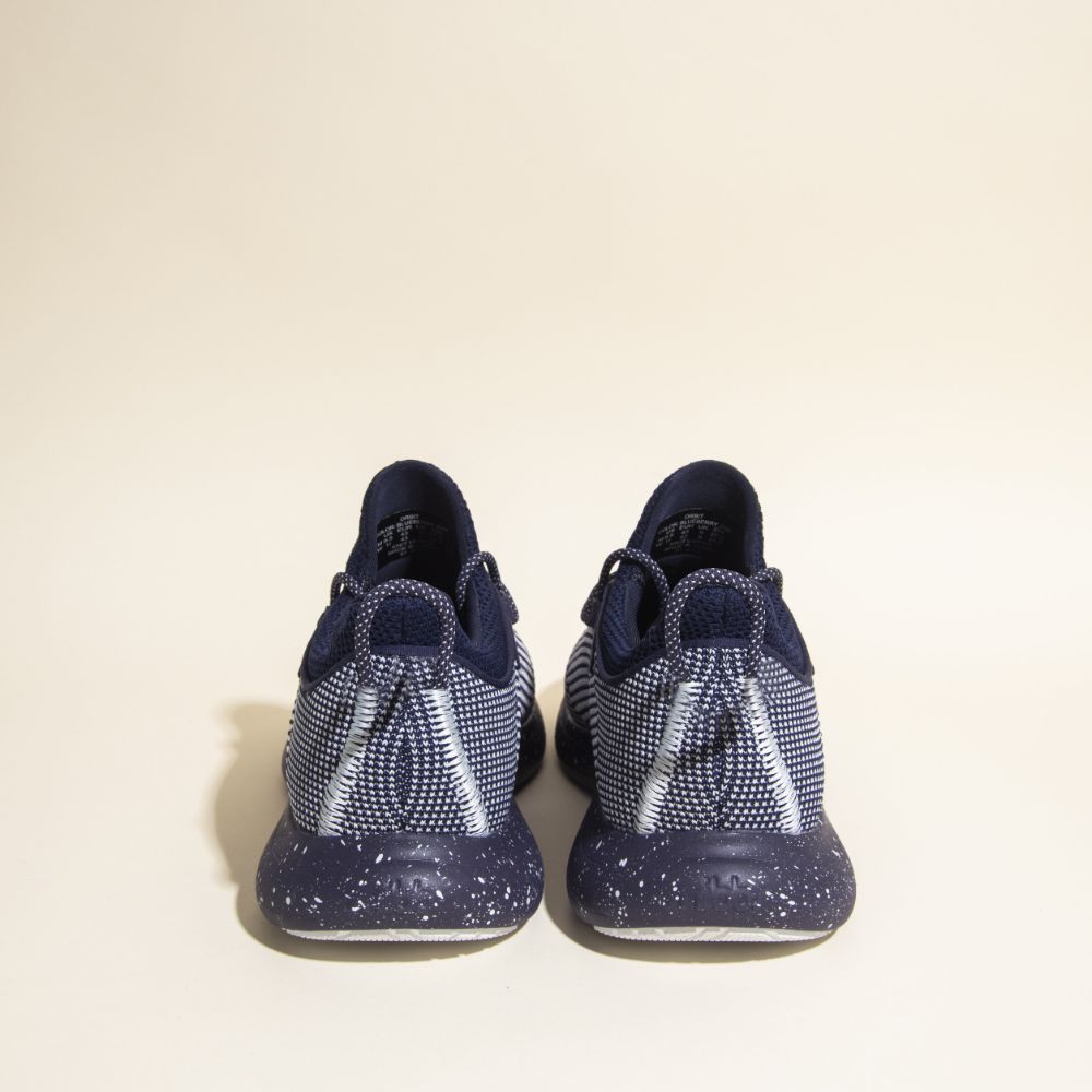 Snibbs Orbit - Blueberry Jam sneakers, breathable knit upper, white accents, speckled soles, back view on beige background.