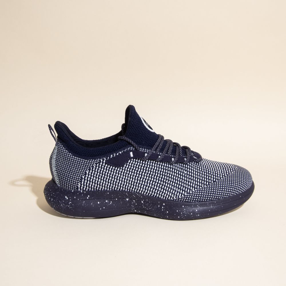 Snibbs Orbit - Blueberry Jam: side view of navy/white knit sneaker with speckled sole on beige background.
