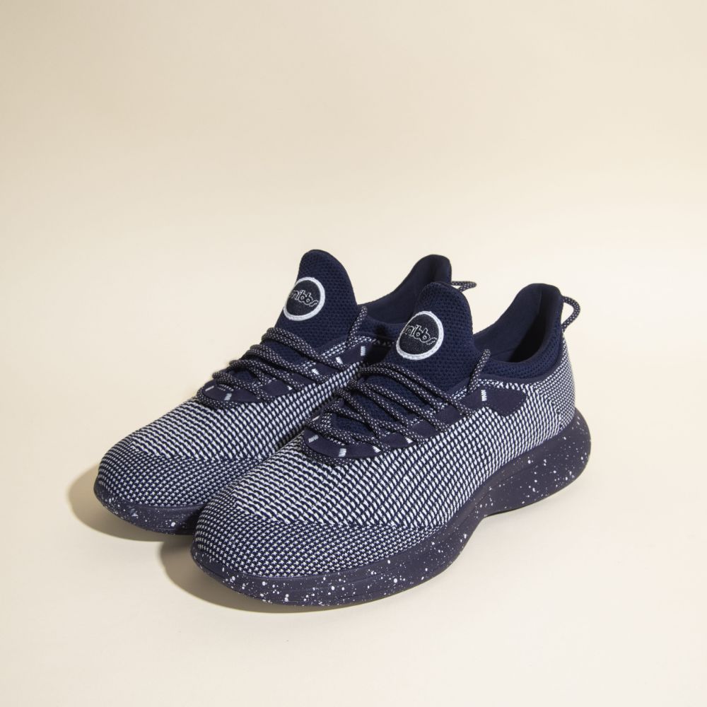 Snibbs Orbit - Blueberry Jam: Navy sneakers with a breathable knit upper and white speckled, slip-resistant soles.
